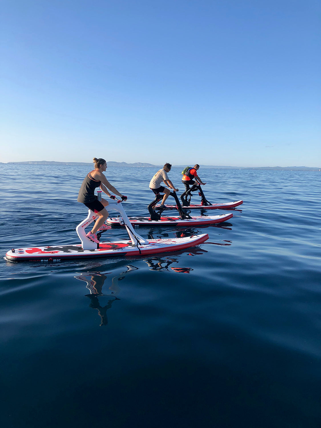 Pedal-powered Surf-Cycle water bike rental on Flathead Lake—delivered to lake cabins, docks, and Montana waterfronts for family-friendly cruising fun. Rent at MontanaBoarders.com