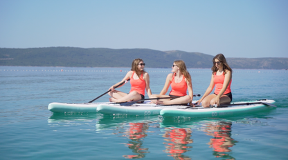 Three girls on three SipaBoards self-inflating electric paddleboard rental with built-in propulsion and Bluetooth remote, delivered to Flathead Valley lakefronts.