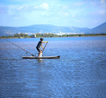 Fisherman paddling on inflatable paddleboard isup casting a line on Flathead Lake | Rent fishing gear from MTBoarders.com with delivery included. Or buy now from e-boarders.com