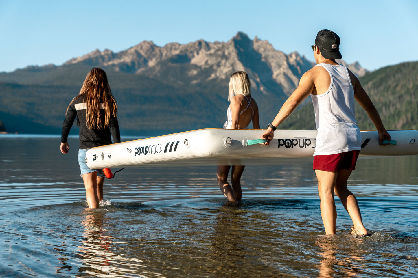 Inflatable lake furniture bundle rental with floating dock, lounge chairs, and table—delivered to waterfront properties in Flathead Valley, Montana. Rent from MontanaBoarders.com purchase from flagship partner eboarders.com