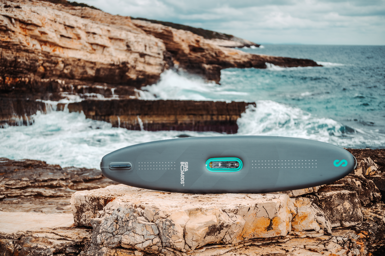 Bottom view of SipaBoards self-inflating electric paddleboard rental with built-in propulsion and Bluetooth remote, delivered to Flathead Valley lakefronts.