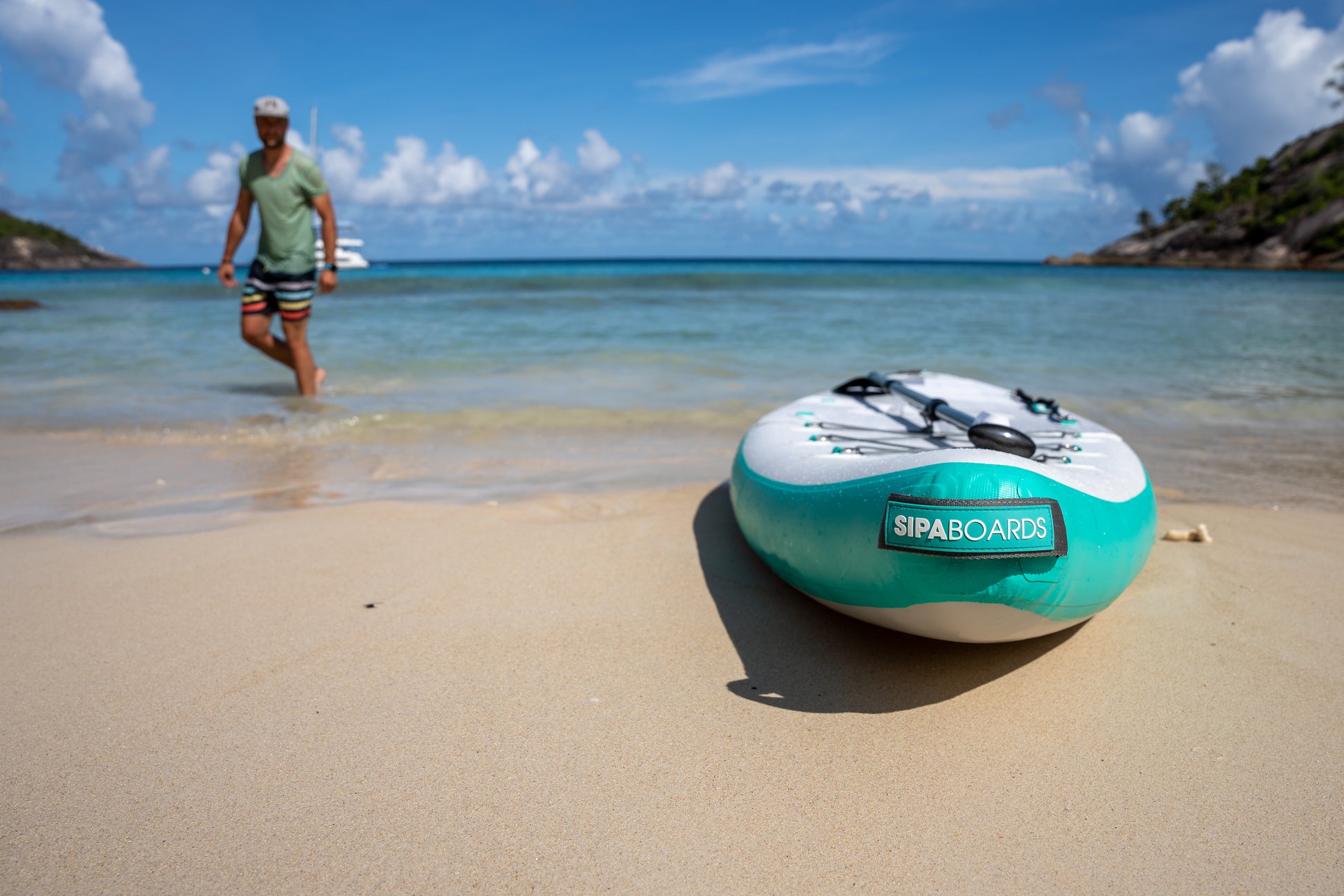 On sand sits the SipaBoards self-inflating electric paddleboard rental,delivered to Flathead Valley lakefronts.