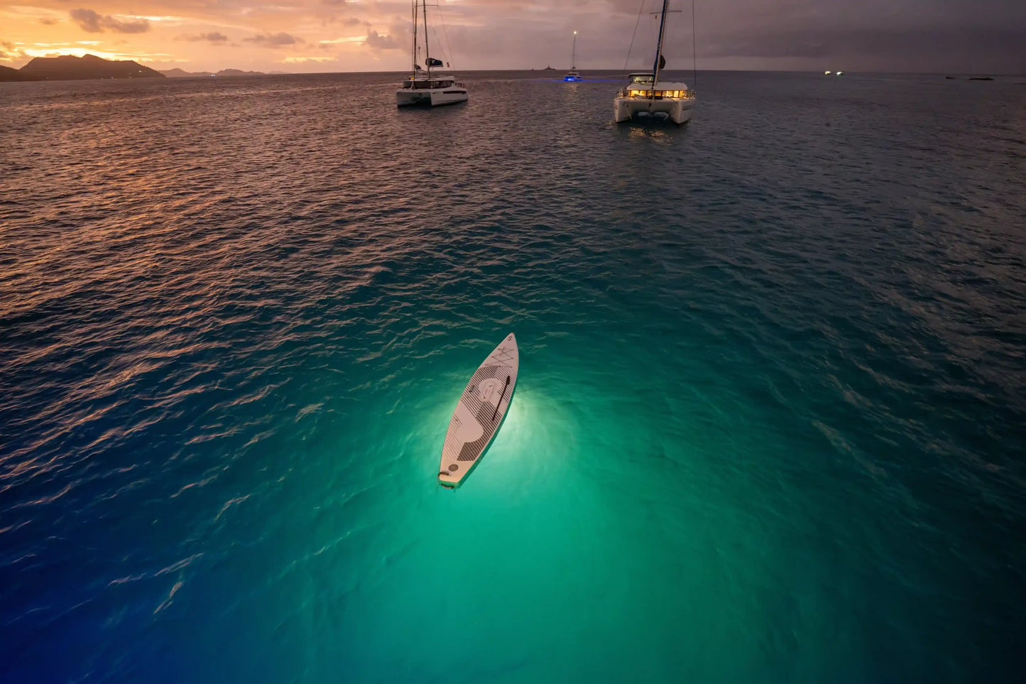 Night LED view of SipaBoards self-inflating electric paddleboard rental with built-in propulsion and Bluetooth remote, delivered to Flathead Valley lakefronts.